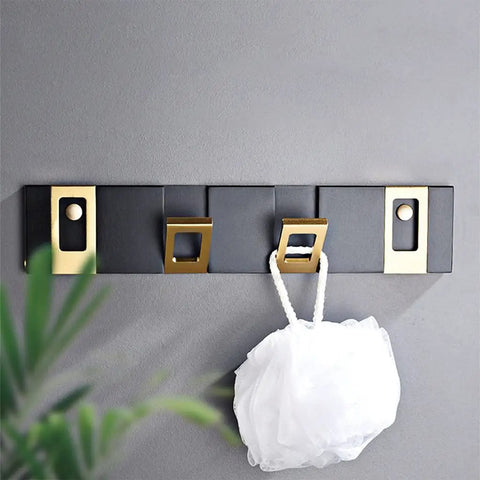 Heavy Duty Nail Free Wall Coat Rack With Sleek Hidden Hooks For Bathroom Bedroom And Entryway Zero Mess Setup Top Tier Organization Sturdy Multi Use Hanging Rack Four Pack mounted on gray wall with a white scrubbing pad.