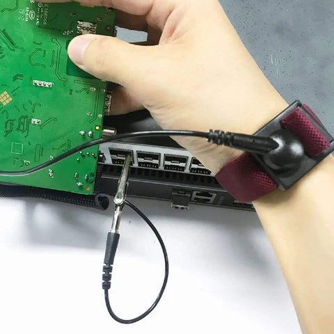 Adjustable ESD Wrist Strap Set Four Pack For Working On Sensitive Electronics; person holding circuit board wearing wristband