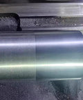 RHKING mini lathe burnishing tool with polished metal cylinder on lathe bed.