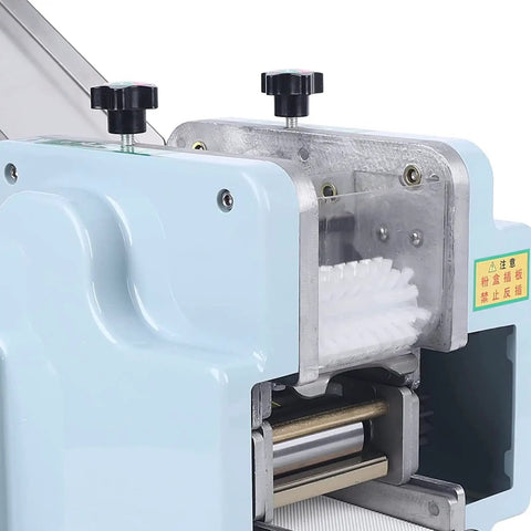 Hella Fast Automatic Dumpling Skin Maker Whips Up Ravioli Sheets And Pasta Dough Presser close-up of machine controls and rollers.