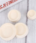 4pcs Rubber Sink Stopper White with Hanging Ring for Laundry Bathtubs, showing four rubber stoppers on a wooden surface.