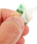 Self Adhesive PCB Standoffs With Hella Secure Insulated Foot Pads For Circuit Boards, showing a hand holding an adhesive spacer.
