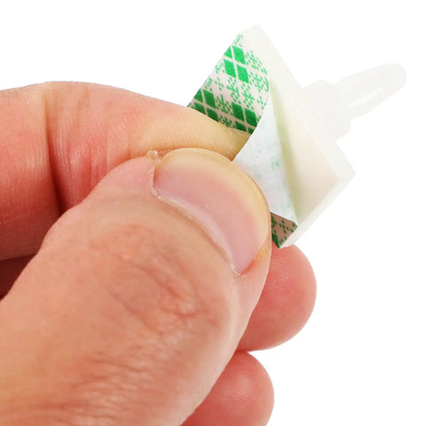 Self Adhesive PCB Standoffs With Hella Secure Insulated Foot Pads For Circuit Boards, showing a hand holding an adhesive spacer.