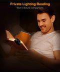 Front view: Gritin rechargeable book light clipped to open book, black clip-on light with flexible goose neck