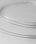 No Hassle Pro Grade Easy Flow Silver Solder Wire For Jewelry Making And Repair, thin coils of soft silver wire on a surface.