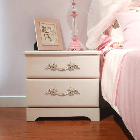 Pack Of 5 European Style Vintage Cabinet Handles And Drawer Pulls Antique Dresser Knob Set For Cupboards And Cabinets With Retro Charm Golden Finish And Included Mounting Screws Ideal For Cabinets Cupboards Dressers And Chests installed on a beige dresser next to a bed