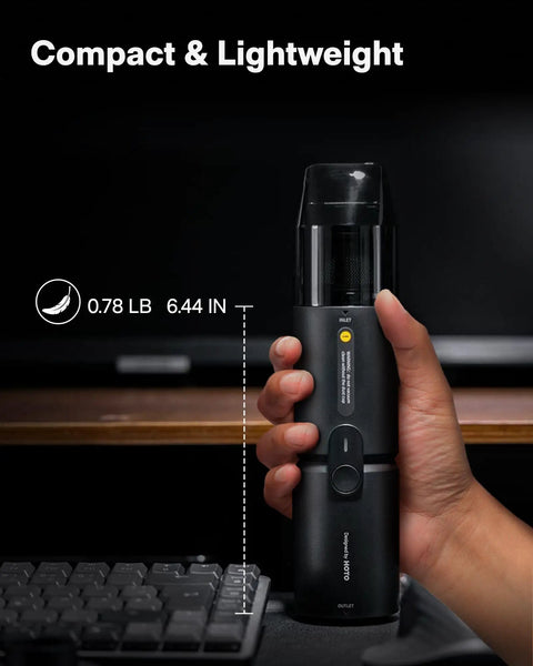 Person holding Cordless Handheld Vacuum Cleaner Four In One Air Duster And Desk Vacuum with 15000Pa suction near keyboard