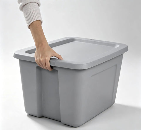 Person holding the handle of a Heavy Duty 30 Gallon Plastic Storage Bin With A No Hassle Snap Closure built tough.