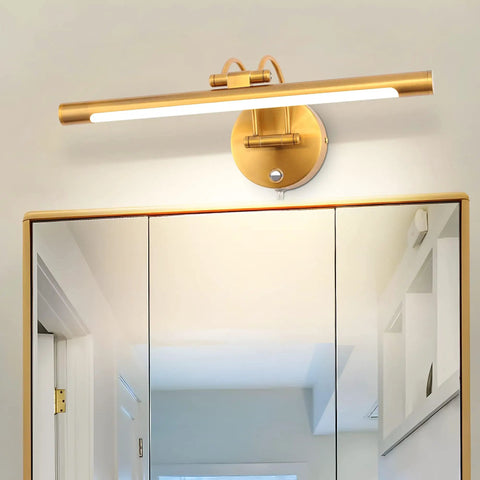 Gold picture light mounted over a bathroom mirror, illustrating the LED over mirror lighting solution