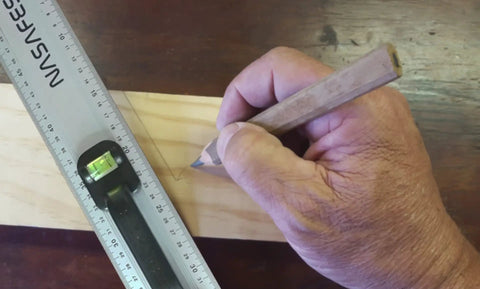 Person using aluminum handle ruler for precise cuts, 55cm centimeter ruler with dual-sided CM markings on wood surface
