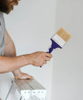 Man using adjustable 3 inch paint brush with 270 degree angled head and 2.6 cm aperture for walls, furniture, deck and acrylic projects.