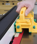 Two Piece 1/8 Inch Thin Rip Push Block Table Saw Safety Jig featuring a hand using the yellow jig near wood slabs.