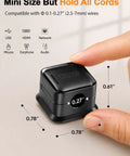 Close-up of hand holding black 8 Pack Cord Organizer Holders With Strong Adhesive Magnetic Cable Management For Desk Home Office And Car Neatly Tidy Phone Chargers USB Cables HDMI Type C Lightning Wires showcasing dimensions.