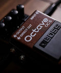 Octave Pedal OC-5 For Guitar And Bass With Mono And Poly Modes on wooden surface, dry direct output visible.