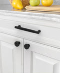 10 Pack 5 Inch Matte Black Knurled Cabinet Pulls for kitchen cabinets with modern minimalist knurling installed on white cupboard