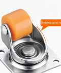 Heavy Duty Half Inch Mini Furniture Casters With Kickass Silent Glide Rubber Tires And Solid Steel Mounting Plates For Quick Home Office Upgrades And Desk Repairs close-up of orange rubber wheel on steel base plate.