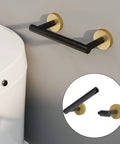 Matte Black And Brushed Brass Finish Double Post Pivoting Toilet Paper Holder Built Tough From SUS304 Stainless Steel Wall Mounted Tissue Holder For Commercial Bathrooms And RVs mounted beside toilet with inset pivot detail