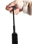 Hand holding RAM-T Rod Telescoping Cleaning Rod for NitroFire and Pursuit XT with flip-out T-handle visible