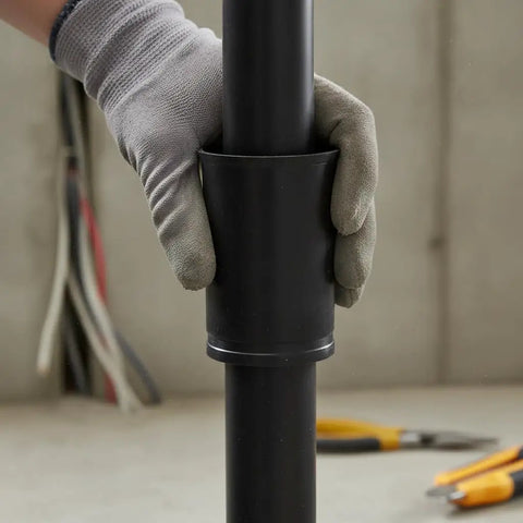Heavy Duty PE Conduit Coupler For Quick Snap Wiring Setup With No Sweat Cable Pull Inside And Zero Heat Fusion Needed For Underground Utilities and Built Tough Industrial Power Runs, being attached by a gloved hand.