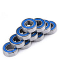 Flanged 5x11x4mm deep groove ball bearing 2RS steel with double shield seals stacked in a pile for rail track linear motion systems