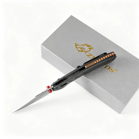 Premium Folding Pocket Knife With Top Shelf Dc53 Steel Blade and Rock Solid Aluminum Handle resting on a grey box.