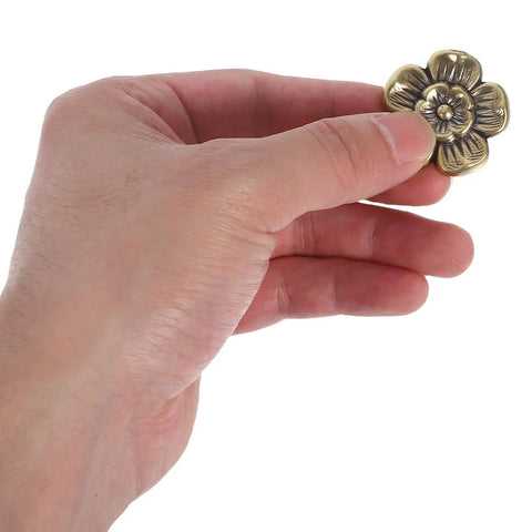 Hand holding a floral decorative handle from Antique Brass Cabinet Knobs 2 Pack Floral Drawer Pulls Decorative Handles For Kitchen Cabinets Wardrobes And Furniture Replacement Hardware With Solid Brass Construction And A Classic Retro Vibe