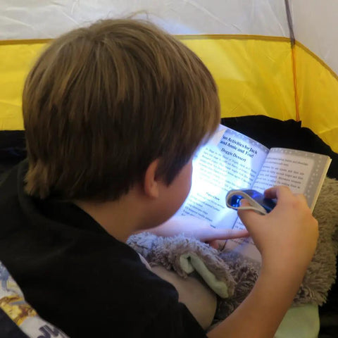 Child reading in tent with blue Hand Crank Emergency Flashlight Four Pack Rechargeable Crank Light With Dual LED