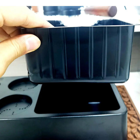 Matte Black Coffee Tamping Station With Knock Box Powder Organizer For Espresso Prep, user holding the knock box.