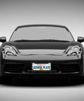 Front view of a black car with Dope Leopard Print License Plate Frames 2 Pack Aluminum Rustproof Waterproof Car Tag Frame With Screws And Caps Cheetah Style.