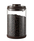 Round High Borosilicate Glass Coffee Bean Container With Real Deal Airtight Seal Keeps Your Morning Brew Cache Fresh And Stores Loose Tea Sugar Or Ground Coffee For Total Kitchen Flex No Cap Leakage Guaranteed with coffee beans inside.