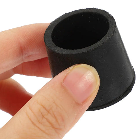 Close-up of an Anti Slip Rubber Feet for Furniture 8 Pack Thickened Grippy Floor Protectors being held, showcasing round black rubber material.