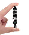 Hand holding 90mm Dual Rate Spring Oil Shock with CNC aluminum shock bodies and nylon bottom rod ends for TRX4 SCX10 1 by 10 RC Crawler.
