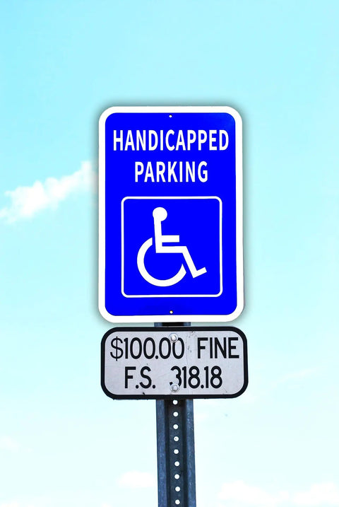 Heavy Duty Aluminum Handicap Parking Sign Ada Compliant Reflective Metal Plaque mounted on a pole against a blue sky.