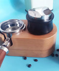 Top Shelf Dual Head Coffee Distributor And Tamper Kit Featuring Quick Rebound Design Crafted From Solid 304 Stainless Steel on a wooden base.