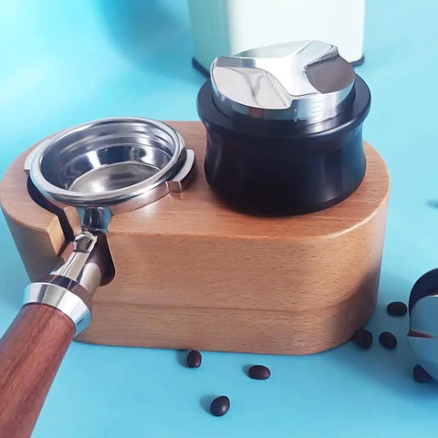 Top Shelf Dual Head Coffee Distributor And Tamper Kit Featuring Quick Rebound Design Crafted From Solid 304 Stainless Steel on a wooden base.