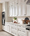 Modern kitchen with white cabinetry featuring Riverside Pull In Honey Bronze Finish, 5 1/16 Inch Length, T Shaped Bar Handles