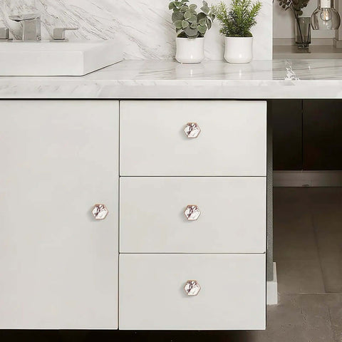 4 Pack Hexagon Cabinet Knobs With Solid Brass Construction And Calacatta Viola Marble Texture Brushed Gold Finish on white drawers