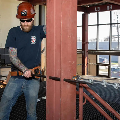 Worker using Made in USA Round 7/8 Inch by 36 Inch Connecting Bar For Solid Aligning Prying And Chiseling Ergonomic Pro Grade Sleever Bar