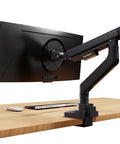 Heavy Duty Single Monitor Arm, Premium Aluminum Desk Mount With Butter Smooth Adjustments, Rock Solid C Clamp Plus Grommet Base For Screens Up To 39 Inches, Matte Black, mounted on desk with laptop and mouse.