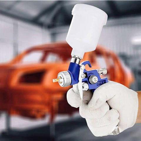 Pro Level Mini Hvlp Paint Sprayer With Gravity Feed Cup And Genuine Stainless Steel 1.0Mm Nozzle, handheld in use for detailing.