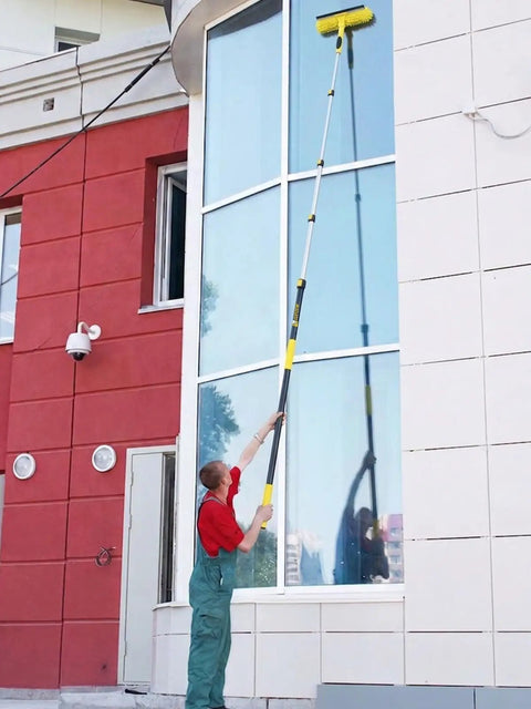 Person using Heavy-Duty Commercial Extension Pole Delivers 4.5 To 18 Ft Reach For True Two-Story Access Up To 24 Ft Total on building