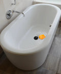 Fish Bathtub Drain Stopper with Chain Rubber for Shower Drains in a modern white tub with orange fish decoration.