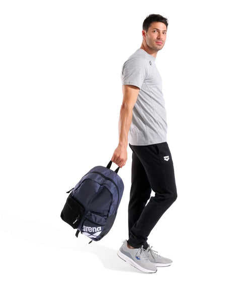 Man holding Do It All Swim And Sports Backpack 30L Navy Blue For Men And Women Multisport Daypack With Top Loading Main Compartment Wet And Dry