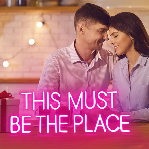 Couple with "This Must Be The Place Neon Sign Pink Wall Decor For Bedroom And Party Vibes, Large Quote Neon Light For Home Decor, Perfect Anniversary Or Birthday Gift For Him Or Her, 23 By 9 Inches"