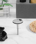 Rotary Bath Tub Plug Drain Stopper for Bathtub Overflow Cover in chrome finish, resting on a marble surface with natural decor.