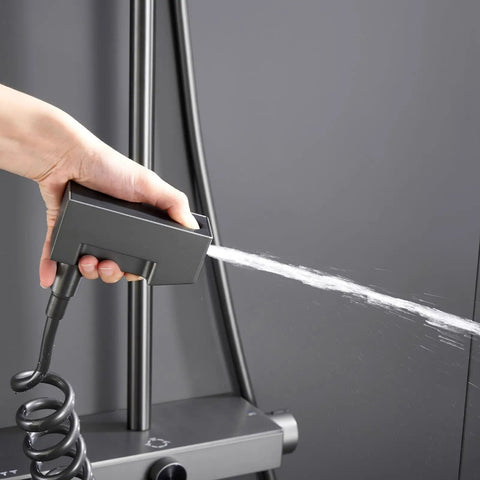 Handheld sprayer in use, part of UMJIGF Shower System Thermostatic 4-Function Shower Faucet Set, ergonomic design.