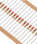 Front view of beige carbon-film axial resistors with color bands arranged on a strip in packaging.
