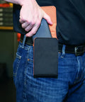 Person using Phone Holder With Magnetic Closure And Belt Clip For iPhone Google LG And Samsung Fits Phones In Or Out Of Protective Case Up To 6.25 By 3.75 By 0.75 Inches Built From Durable 1680D Ballistic Nylon Built For Everyday Carry on jeans