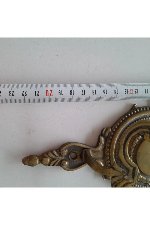 Close-up of Robust Vintage Brass Wall Hook with Classic Old School Charm and Tough Build for Entryway or Bathroom Decor.