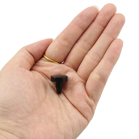 Hand holding a single black foot from 40 Pcs PE Curved Adjustable Furniture Leg Fittings Leveling Feet for Desks Tables Shelves Cabinets